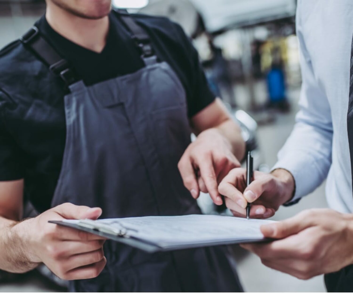 Two people signing a contract