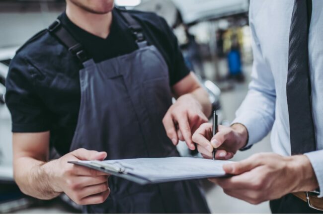 Two people signing a contract